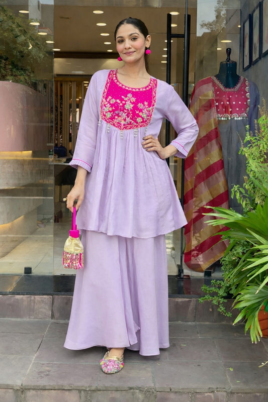 Floral embroidery, fine zari work, and pearl tassels for a rich festive look.